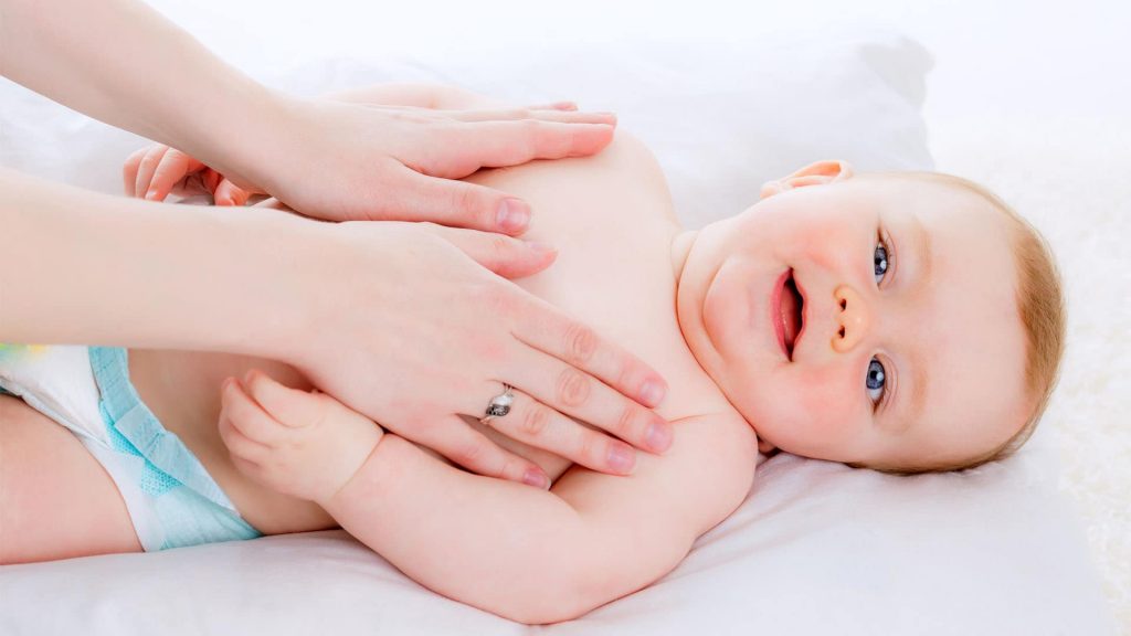 baby getting massage on chest